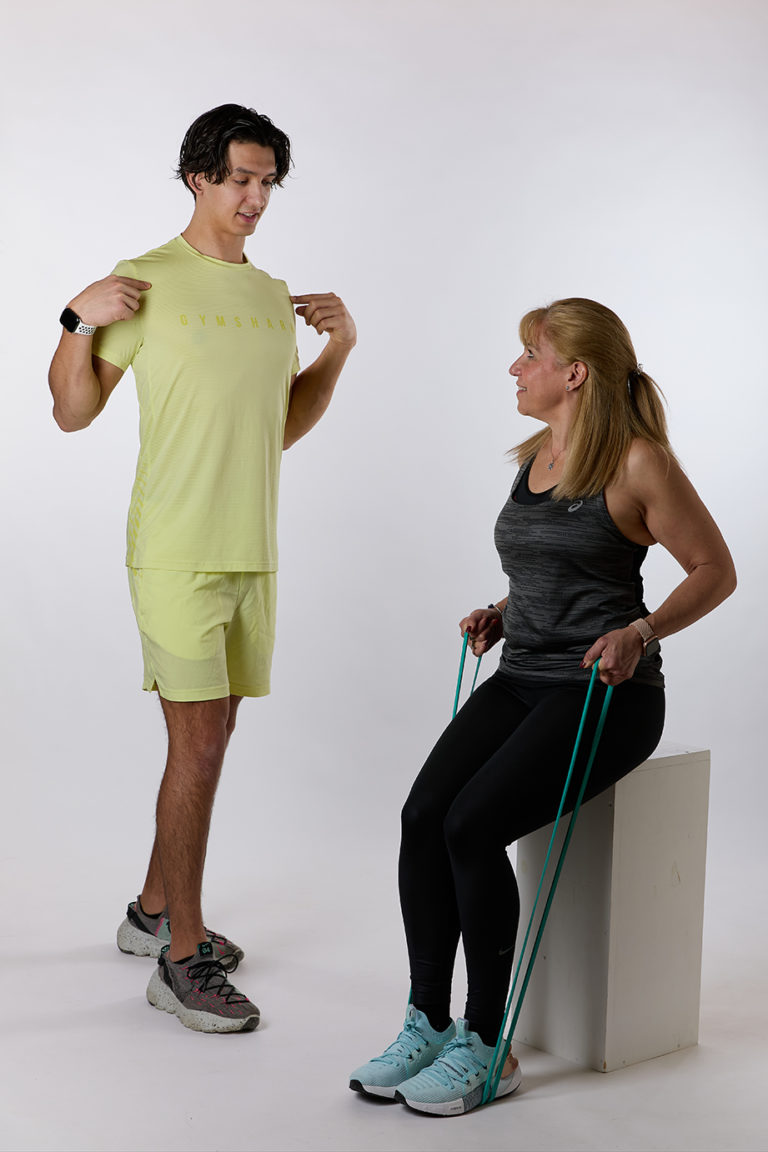 Florian Passet accompagne une cliente pendant un exercice avec élastique